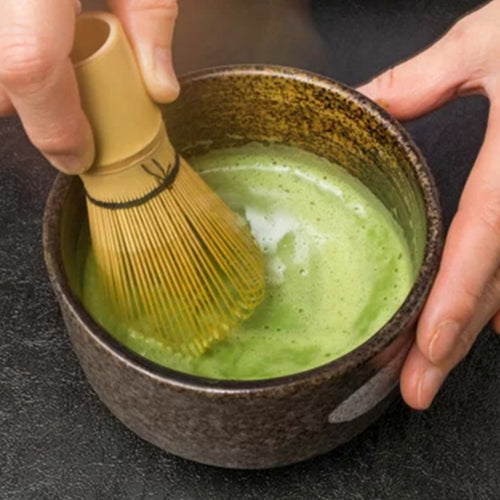 Creating fine foam with bamboo whisk and premium green tea powder